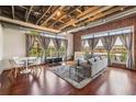 Well-lit living room with hardwood floors, exposed ceiling, and large windows offer neighborhood views at 791 Wylie Se St # 102, Atlanta, GA 30312