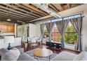 Spacious living area features exposed ductwork, modern decor, and natural light from large windows at 791 Wylie Se St # 102, Atlanta, GA 30312
