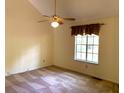 Bright bedroom featuring neutral walls, carpeted floors, and a ceiling fan for added comfort at 997 Timbervale Ln, Lithonia, GA 30058