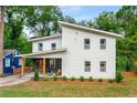 Elegant white two-story home with a welcoming front porch and neatly landscaped front yard at 1335 Elizabeth Ave Sw, Atlanta, GA 30310