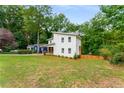 Stylish two-story home with modern architecture and a lush green lawn, surrounded by mature trees at 1335 Elizabeth Ave Sw, Atlanta, GA 30310
