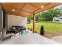 Inviting covered porch featuring stylish seating, a rug, and an open view of the surrounding yard at 1335 Elizabeth Ave Sw, Atlanta, GA 30310