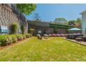 Landscaped backyard with a lush lawn, blooming azaleas, privacy fence, hot tub, and plenty of room to relax at 2075 Old Georgian Nw Ter, Atlanta, GA 30318