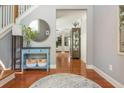 Bright foyer with hardwood floors, stylish console table, and decorative mirror creating a welcoming entrance at 2075 Old Georgian Nw Ter, Atlanta, GA 30318