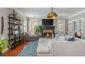 A cozy living room with a fireplace, comfortable seating, hardwood floors, and stylish decor creates an inviting atmosphere at 2075 Old Georgian Nw Ter, Atlanta, GA 30318