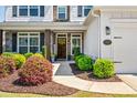 Inviting front porch with stone details, stylish door, and meticulously maintained landscaping at 4105 Woodwind Dr, Cumming, GA 30028