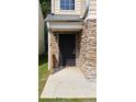Close up of entryway with charming stone facade and black metal door at 5169 Hanover St, Atlanta, GA 30349