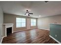 Spacious living room with fireplace, ceiling fan, and wood-look flooring at 5169 Hanover St, Atlanta, GA 30349