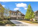 Charming two-story home featuring a well-manicured lawn and attached garage at 1285 Brynhill Ct, Buford, GA 30518