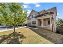 Attractive two-story home with a well-kept lawn, two car garage and inviting front porch at 1285 Brynhill Ct, Buford, GA 30518