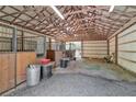 Inside a well-maintained barn featuring multiple stalls and a gravel floor at 1819 Yorkshire Dr, Woodstock, GA 30189