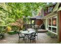 Outdoor brick patio with seating and dining areas, perfect for entertaining at 4300 Valley Trail Dr, Atlanta, GA 30339