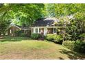 Inviting home featuring manicured lawn, mature trees, and classic architecture at 4300 Valley Trail Dr, Atlanta, GA 30339