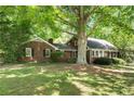 Brick home with large front yard and shade tree at 4300 Valley Trail Dr, Atlanta, GA 30339