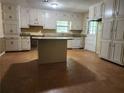 Functional kitchen featuring a large island, ample cabinet space, and a window over the sink at 69 N Hearn Rd, Ellenwood, GA 30294
