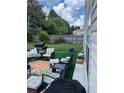 Backyard patio with outdoor seating, a grill, and a view of the wooded surroundings at 7881 Chadwick Ln, Riverdale, GA 30274