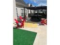 Backyard with a hot tub, outdoor seating, and a patio area, perfect for entertaining at 7881 Chadwick Ln, Riverdale, GA 30274