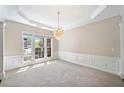 Bright living room with large windows, recessed lights, and an elegant chandelier at 1330 Badingham Dr, Cumming, GA 30041
