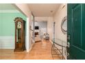 Inviting entryway with hardwood floors, a grandfather clock, and a clear view into the spacious living room at 4557 Waldens Farm Ct, Powder Springs, GA 30127