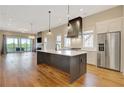 Modern kitchen featuring a large island, stainless steel appliances, and plenty of natural light at 1130 Lupo Loop, Chattahoochee Hills, GA 30268