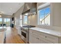 Well-equipped kitchen with stainless steel appliances, white marble countertops, and hardwood floors at 1130 Lupo Loop, Chattahoochee Hills, GA 30268