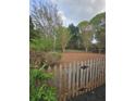 Spacious backyard featuring mature trees, a wooden fence and a neatly mulched ground cover at 2012 Grove Park Ct, Marietta, GA 30062