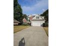 A beautiful, well-maintained home featuring a two-car garage and a long driveway at 2012 Grove Park Ct, Marietta, GA 30062