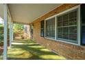 View of the cozy brick covered porch featuring classic columns, a secure entrance, and ample natural light at 4166 Rue Saint Michel, Stone Mountain, GA 30083