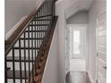 View of staircase with wood steps, iron railings, and white walls at 600 Broadview Ne Ter, Atlanta, GA 30324