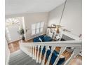Open-concept living room with a fireplace, blue sofa, and plenty of natural light at 3076 Nectar Dr, Powder Springs, GA 30127