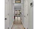 Bright hallway featuring multiple doors, light gray paint, and hardwood flooring at 1021 Windy Oaks Se Ct, Smyrna, GA 30080