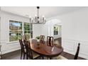 Inviting dining room with hardwood floors and elegant trim, featuring an archway to the entryway at 2181 Poplar Grove Ct, Snellville, GA 30078