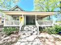 Inviting home with a spacious front porch, featuring seating area, perfect for relaxing at 635 Sw Queen Sw St, Atlanta, GA 30310