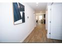 Bright hallway with wood floors leading to the kitchen and dining area at 734 Great Oak Pl, Villa Rica, GA 30180