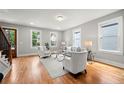 Open living room with gleaming hardwood floors, abundant windows, and a comfortable seating arrangement at 106 Hogue St, Atlanta, GA 30312