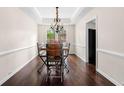 Dining room features stylish lighting, trim detail, and hardwood floors at 3969 Bear Ridge Nw Pl, Kennesaw, GA 30144