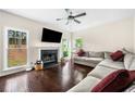 Bright living room with fireplace, hardwood floors, and large windows overlooking the backyard at 3969 Bear Ridge Nw Pl, Kennesaw, GA 30144