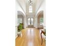 Bright foyer with high ceilings, arched entryways, and a glass-paneled front door at 6765 Creek View Ln, Cumming, GA 30041