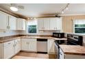 Well-lit kitchen features white cabinets, tile backsplash, modern appliances, and stylish countertops at 1336 Shirley Dr, Sugar Hill, GA 30518