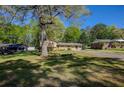 Expansive yard with mature trees surrounding the home, offering a serene and private setting at 1336 Shirley Dr, Sugar Hill, GA 30518