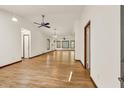 Bright and spacious living room with hardwood floors, white walls, large windows, and ceiling fans at 1878 Suwanee Roberts Ct, Lawrenceville, GA 30043