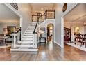 Elegant foyer with hardwood floors, a grand staircase, and sophisticated decor at 10355 Oxford Mill Cir, Johns Creek, GA 30022