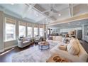 Bright and airy living room with coffered ceilings, hardwood floors, and large windows at 147 Johnston Farm Ln, Woodstock, GA 30188
