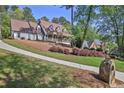 Beautiful home with a long driveway and a meticulously landscaped front yard at 7700 Dunvegan Close, Atlanta, GA 30350