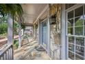 Close-up of a covered front porch featuring stone columns and a stone floor at 7700 Dunvegan Close, Atlanta, GA 30350