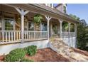 Inviting front porch with stone accents and a charming entrance at 7700 Dunvegan Close, Atlanta, GA 30350
