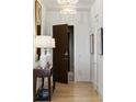 Hallway with hardwood floors, modern lighting, decor and an entryway to another room at 3107 Peachtree Ne Rd # 1403, Atlanta, GA 30305