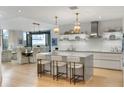 Modern kitchen featuring an island with seating, modern appliances, and views into the dining area at 3107 Peachtree Ne Rd # 1403, Atlanta, GA 30305