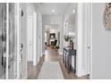 Welcoming entryway featuring hardwood floors, elegant console table, and seamless transition to the living area at 3547 Cedarvale Ct, Powder Springs, GA 30127