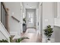 Inviting hallway with stylish decor, hardwood floors, and smooth transition to the rest of the home at 3547 Cedarvale Ct, Powder Springs, GA 30127